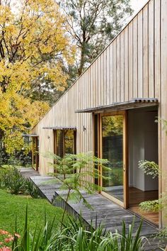 a house with wooden siding and glass doors