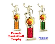 three trophies with the names female basketball trophy on them and an image of a person holding a basketball