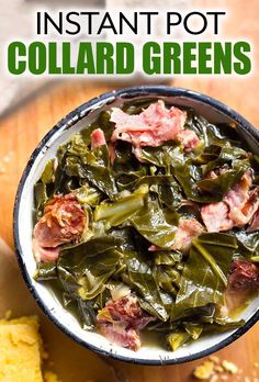 a bowl filled with meat and greens on top of a wooden table next to cornbreads