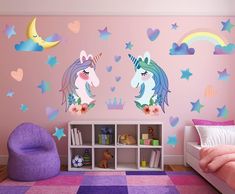 two unicorns with hearts and stars on the wall in a child's bedroom