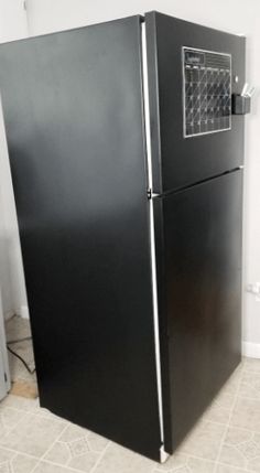 a black refrigerator freezer sitting inside of a kitchen