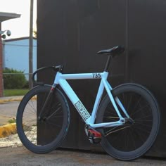 a blue bicycle leaning against a black box