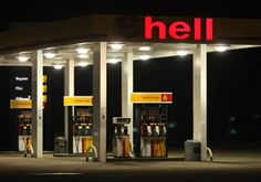 a gas station at night with the lights on and no one around it is there