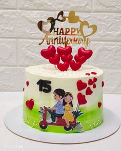 a happy anniversary cake decorated with hearts and an image of a couple on a scooter