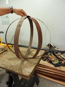 a person working on a piece of wood with a circular object in the middle of it