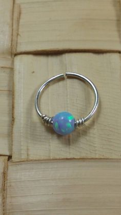 "Nose ring hoop for pierced nose. Opal nose ring. silver nose ring or Gold filled nose ring. pink opal nose piercing. Material - Sterling silver or Gold filled and Opal bead. Opal colors- blue, light blue, dark blue, pink, white , green. Measurement - 20, 22 gauge. inner diameter-(Hoop diameter)-7-10mm (choose at the top right of this page). To save for later click \"Add item\" to \"favorites\". If you have any questions feel free to convo me. please note- sold individually ,not in pairs. Each a Adjustable Nickel-free Septum Ring, Adjustable Internally Threaded Septum Ring, Minimalist Adjustable Hoop Septum Ring, Adjustable Hypoallergenic Sterling Silver Nose Rings, Adjustable Sterling Silver Hoop Septum Ring, Internally Threaded Round Nose Rings As Gift, Small Hoop Nose Ring With Internal Threads For Gift, Gift Small Hoop Internally Threaded Nose Rings, Round Internally Threaded Nose Rings For Gifts