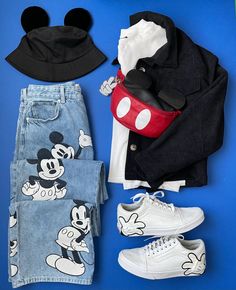 the mickey mouse outfit is laid out on a blue surface with other items including shoes and clothing