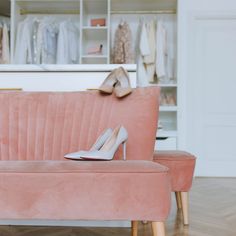 a pink couch with high heels on it