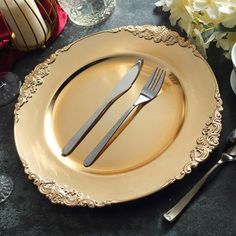 there is a gold plate with silverware on it