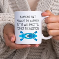 a woman holding a coffee mug with kayaking isn't always the answer, but it will make you forget the question