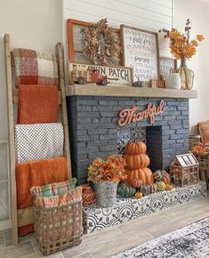 a living room filled with lots of fall decorations and decor on top of a fireplace