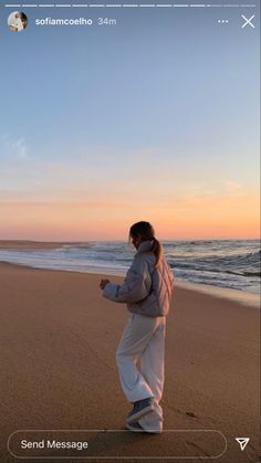 a person standing on top of a sandy beach