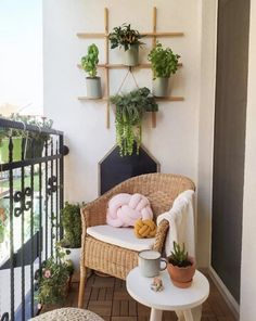 a wicker chair sitting on top of a wooden floor next to a potted plant