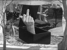 a black and white photo of a person's hand in a box