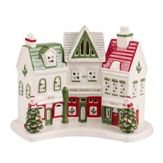 a white and green christmas village with trees