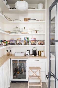 an instagram photo of a kitchen with white cabinets and open shelving