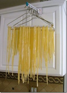 spaghetti hanging from the ceiling in a kitchen