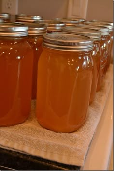 several jars filled with liquid sitting on top of a counter