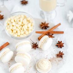 an assortment of desserts on a plate with cinnamon sticks and star anise next to it