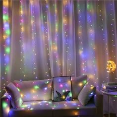 a living room filled with furniture covered in colorful lights and stars on the wall next to a window