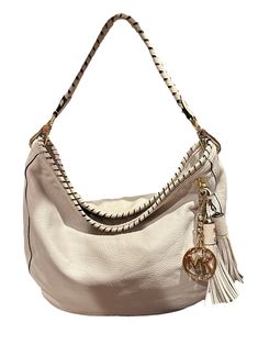 This function-with-style hobo handbag by KORS Michael Kors is crafted from off-white leather. The flat handle is wrapped in leather to match the wrapped opening. Gold tone hardware with logo zipper tabs and the MK dangling logo charm next to a fun duo of leather tassels.  The interior is lined with fabric and features three slip pockets. Condition  One tassel shows a minor mark. See last photo Designer Beige Leather Hobo Bag, White Hobo Bag With Zipper And Double Handle, White Leather Hobo Bag With Zipper Closure, Luxury Cream Hobo Bag With Handle Drop, White Double Handle Hobo Bag With Zipper, White Leather Hobo Bag For Shopping, Designer Hobo Tote Bag With Zipper, White Hobo Bag With Gold-tone Hardware Crossbody, White Hobo Bag With Gold-tone Hardware For Everyday Use