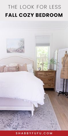 a white bed sitting in a bedroom next to a dresser