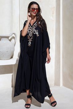 Add a tribal twist to your beach time in this black and gold summer maxi swimwear cover up. Zigzag embroidery adds a spicy accent to this long beach caftan, with a casual vacation vibe and a loose flowy fit that works beautifully on plus sizes. It offers great sun coverage, and is so easy to wear for cruises, lounging, vacation or relaxing days at the beach. Back From Bali is dedicated to creating beautiful, quality clothing with a heart. All of our items are crafted, sewn and painted by hand in Bali, by local artists and women who own small home businesses. For over 20 years, we have nurtured fair, honest and caring relationships with our artisans and their families – so you can feel as good about wearing our products as they feel about making them. Make waves in this black summer maxi sw Embroidered Kaftan For Beach Cover-up, Summer Vacation Embroidered Maxi Dress, Long Embroidered Beach Kaftan, Vacation Embellished Tunic Kaftan, Embroidered Long Maxi Dress For Vacation, Embroidered Long Kaftan For Beach, Long Embroidered Kaftan For Beach, Embellished Tunic Kaftan For Vacation, Embroidered Beach Kaftan For Beach Season