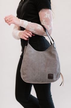 Our Anniston hobo bag is as cute as it is functional. It comes with two magnetic-snap compartments on top of each side of the main zipper-enclosed compartment. This makes it a breeze to throw in your phone or keys that you might need quick and easy access to, while still being able to zip up your wallet or cash in a more concealed and safe compartment. You're going to love the size of this bag too. it's big enough to store your necessities, but you'll never feel like you're carrying around a bul Versatile Hobo Bag With Zipper Pocket For On-the-go, Versatile Everyday Hobo Bag With Zipper Pocket, Everyday Hobo Shoulder Bag With Zipper Pocket, Casual Hobo Bag With Removable Pouch For Everyday Use, Versatile Everyday Shoulder Bag With Cell Phone Pocket, Versatile Shoulder Bag With Cell Phone Pocket, Casual Canvas Hobo Bag For Everyday, Brown Shoulder Bag With Cell Phone Pocket, Brown Shoulder Bag With Cell Phone Pocket For Everyday