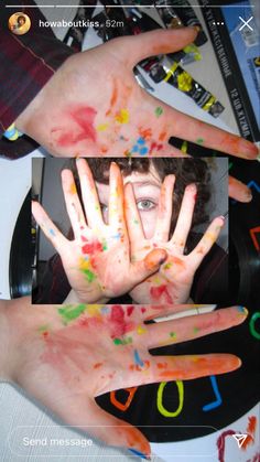 two hands covered in colorful paint with numbers painted all over them and one hand covering the other's face