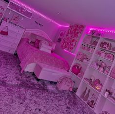 a bedroom with pink walls and carpeted flooring is lit up by purple lights