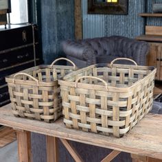 two woven baskets sitting on top of a wooden table