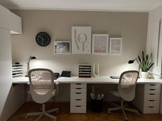 an office with two chairs and a clock on the wall