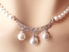 "Elegant, one of a kind bridal necklace and earring set made with 5mm Swarovski crystal core pearls and finished with a delicate .925 sterling silver centerpiece set with delicate cubic zirconia jewels and 8-10mm pearl drops. The necklace length is adjustable from 15.5\"-17.5\". The center focal piece is is 1.5\" wide and 1\" long. The earrings are .75\" long. OOAK, shipped in a free gift box! We have more sterling silver here: https://www.etsy.com/shop/dalfiya?section_id=17442255 We present our Victorian Bridal Necklace, Silver Centerpiece, Wedding Jewelry Sets, Crystal Pearls, Bridal Necklace, Wedding Classic, Earring Set, Jewelry Sets, Swarovski Crystals