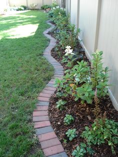 a brick path in the middle of a garden