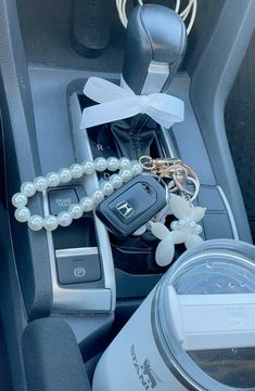 a car keychain and other items are sitting in the center console