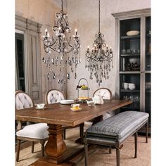 a dining room table with chairs and chandelier