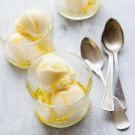 three bowls filled with ice cream and two spoons