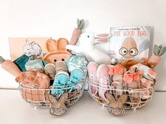 two baskets filled with stuffed animals sitting on top of a white counter next to a book