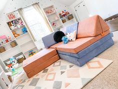 a living room filled with furniture and lots of shelves full of stuffed animals on top of it