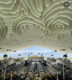 the ceiling is made out of paper and has many tables set up for an event