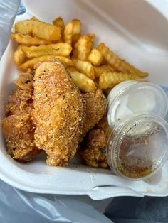 fried chicken and french fries in a takeout container