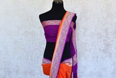 Classic color combination of orange and purple in georgette banarasi saree. Perfect sari for festivals. Disclaimer: The actual product may vary slightly from the image. These are custom orders, hence expect slight variation in color, placement of the motif or buta. ESTIMATED DELIVERYBecause this is a custom order, it would take about 4 weeks from the date of purchase. RETURN POLICYThis product is a custom order and cannot be returned or exchanged. Orange Saree With Border In Traditional Drape, Purple Saree With Border In Traditional Drape, Bollywood Style Purple Saree With Border, Orange Saree With Border For Wedding, Orange Wedding Saree With Border, Purple Banarasi Silk Saree With Border, Georgette Banarasi Saree, Purple Border, Fashion Journals