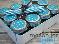 blue and white polka dot cupcakes are in a box with a ribbon on top