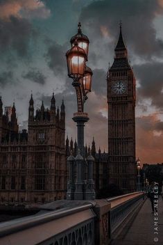 the big ben clock tower towering over the city of london, england at sunset or dawn