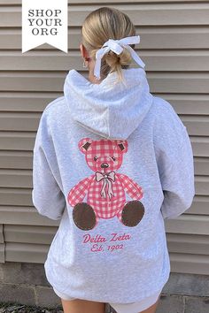 Available in 2XL - 3XL (Click Here) Product ColorAsh Product Details Gildan 18500 50/50 cotton/polyester Product Description Elevate your sorority wardrobe with our Plaid Teddy Sorority Hoodie. Crafted from the softest fabric, this hoodie provides ultimate comfort and style, making it a staple year round. Embrace the perfect blend of warmth and breathability with this must-have addition to your collection About the Design Featuring a trending design, our lightweight hoodie is adorned with an exc Kappa Delta Teddy Bear, Pink Sorority Letters Sweatshirt, Sorority Merch Sweatshirt, Back Of Sweatshirt Designs, Sorority Christmas Shirts, Phi Mu Merch, Sorority Hoodie Design, Sorority Exec Sweatshirts, Sorority Parents Weekend Shirts