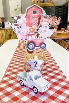 a red and white checkered table cloth with farm animals on it