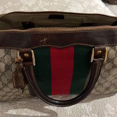 Vintage Gucci Duffle Bag With Lock And Key ! Authentic Purchased From Gucci Many Years Ago.Signs Of Wear But Still Lots Of Life. Authenticated By Posh! See Pics , Some Small Minor Water Stains Inside. This Is A Vintage Bag That Would Be The Condition. For Collectors. Smoke Free Pet Free Home. Measurements Of The Bag Are 14.5”L X 11”H X 6”W.... Vintage And Authentic See Posh Card Gucci Duffle Bag, Lock And Key, Vintage Bag, Water Stains, Vintage Bags, Vintage Gucci, Gucci Bag, Duffle Bag, Bag Lady