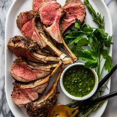 steak with herbs and sauce on a white plate