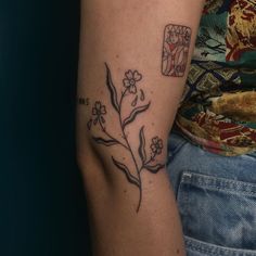 a person with a flower tattoo on their arm