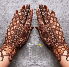 two hands with henna designs on them